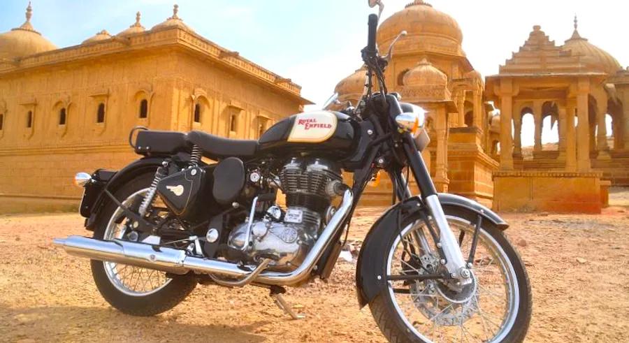 Riding through the vibrant streets of Rajasthan on a classic motorcycle