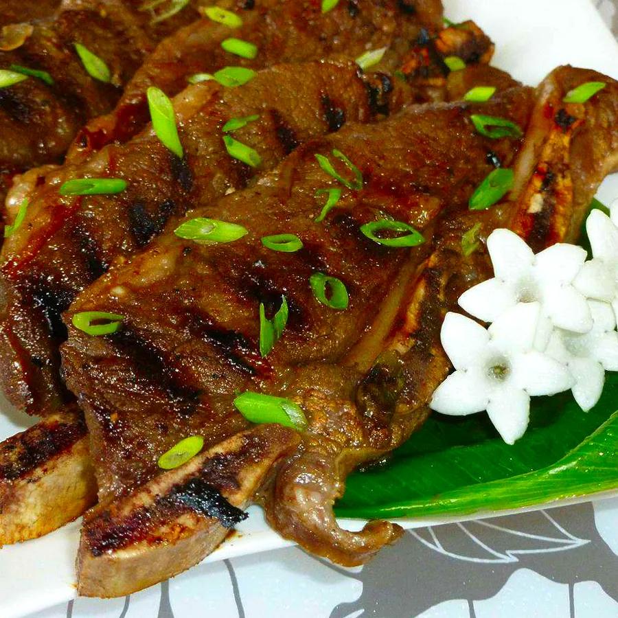 Kalbi, also known as Korean BBQ Short Ribs, is a flavorful dish featuring marinated beef ribs grilled to perfection.