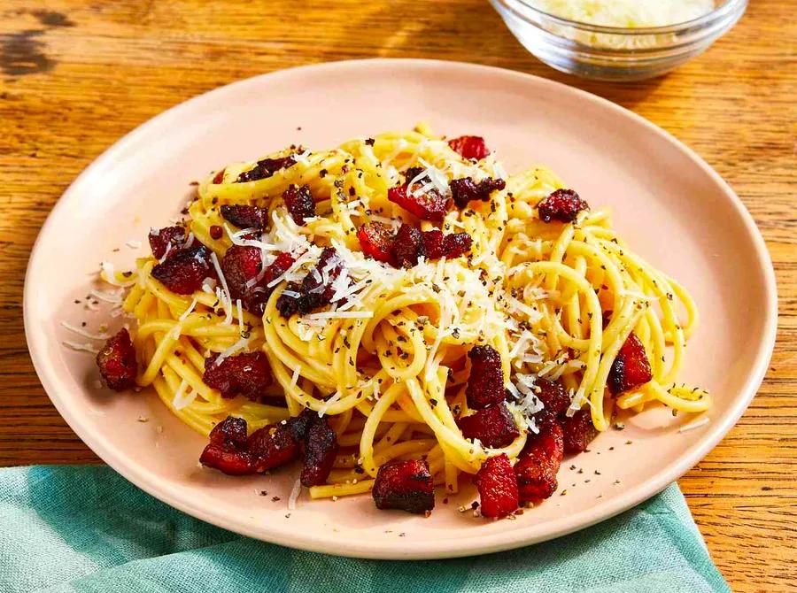 Spaghetti alla Carbonara: A timeless Italian pasta dish with a creamy sauce made from eggs, Pecorino cheese, cured pork, and a sprinkle of black pepper.