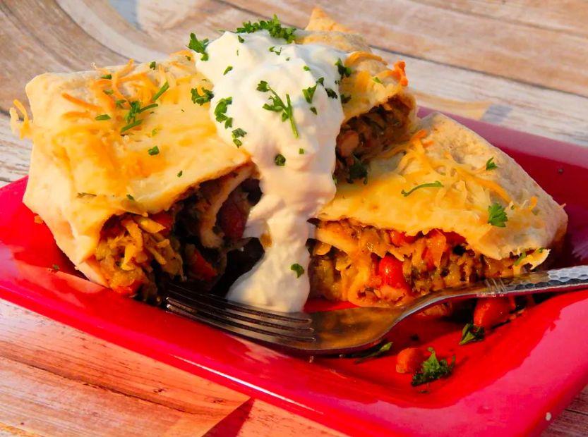 Cover Image for Squash and Zucchini Burritos: A vibrant combination of zucchini, summer squash, and black beans, wrapped in soft tortillas and baked to perfection with a cheesy topping.