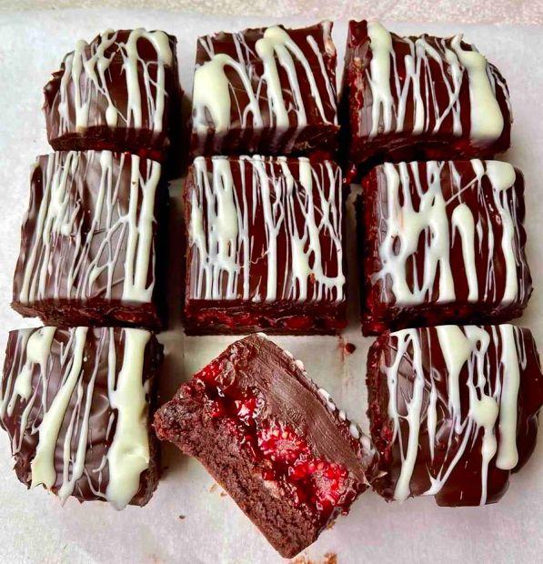 Cover Image for These chocolate-dipped raspberry brownies are the very definition of indulgence, a perfect harmony of rich flavor and decadence.